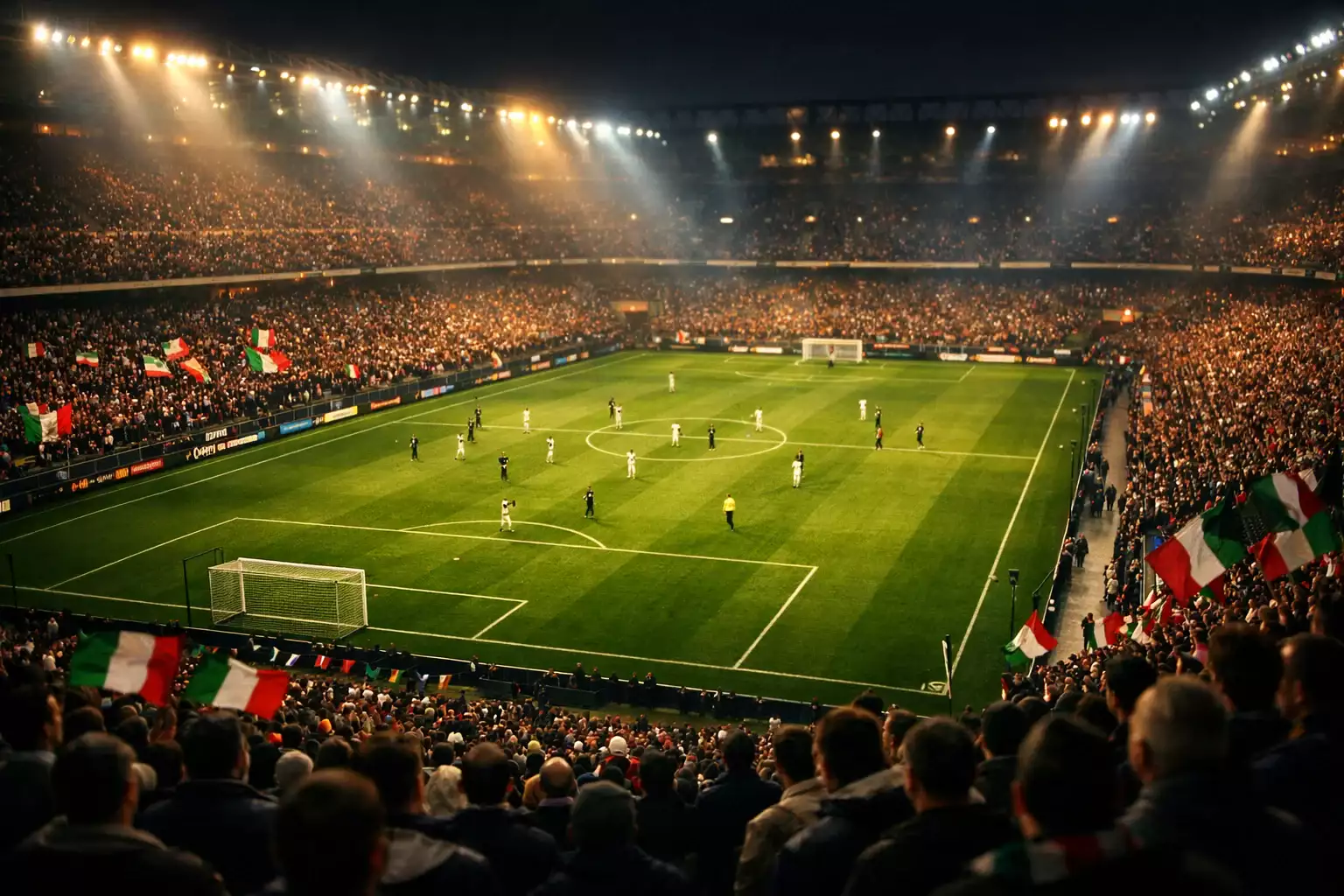 Stadio di calcio illuminato durante una partita serale con tifosi sugli spalti